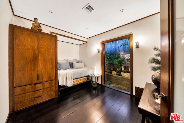 bedroom with dark hardwood / wood-style flooring and access to exterior