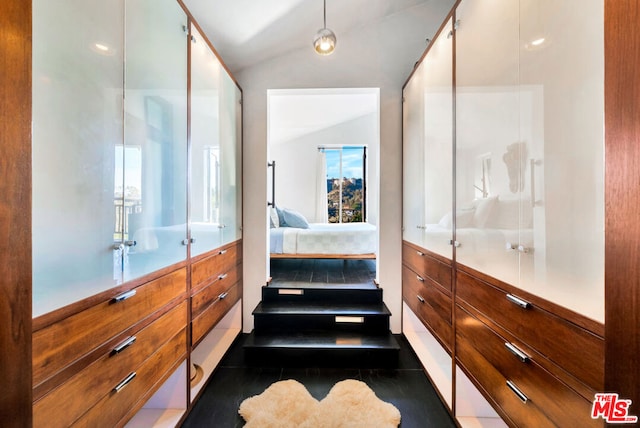 bathroom featuring lofted ceiling and an enclosed shower