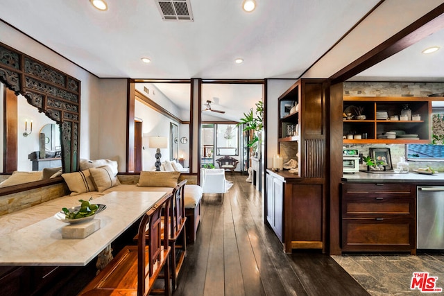 bar with dishwasher, dark hardwood / wood-style flooring, dark brown cabinets, and ceiling fan