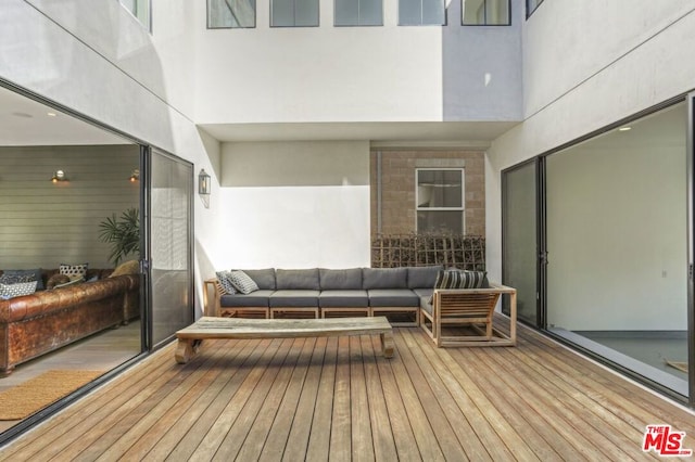 wooden deck featuring outdoor lounge area