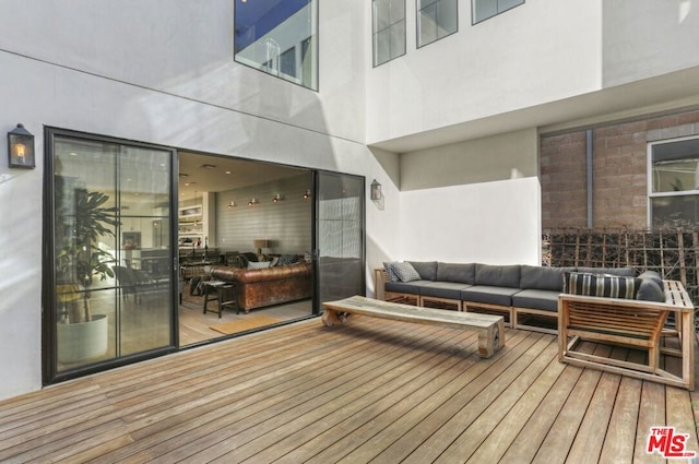 wooden terrace featuring an outdoor living space