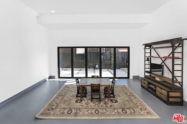 dining area featuring concrete floors