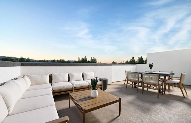 patio terrace at dusk featuring an outdoor living space