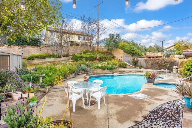 view of swimming pool with a fenced in pool, an in ground hot tub, a fenced backyard, and a patio