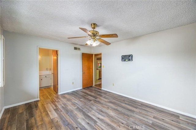 unfurnished bedroom with visible vents, wood finished floors, baseboards, and a textured ceiling