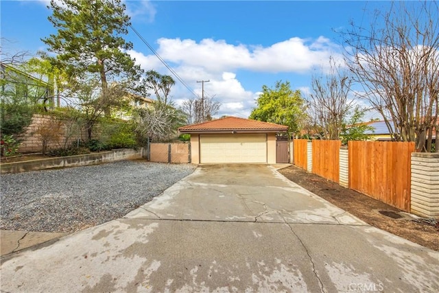 detached garage featuring a gate and fence