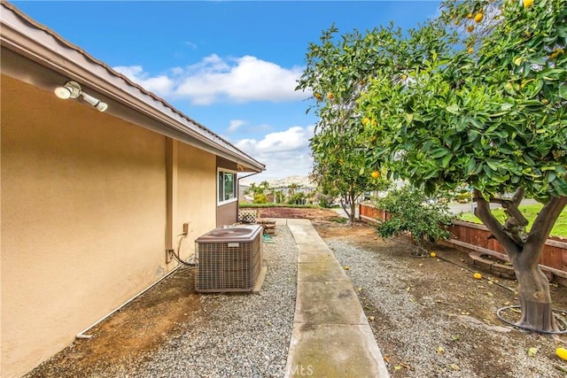 view of yard featuring a patio area, central AC, and fence