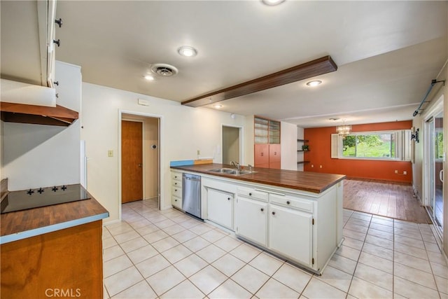 kitchen with wooden counters, black electric stovetop, dishwasher, light tile patterned flooring, and a sink