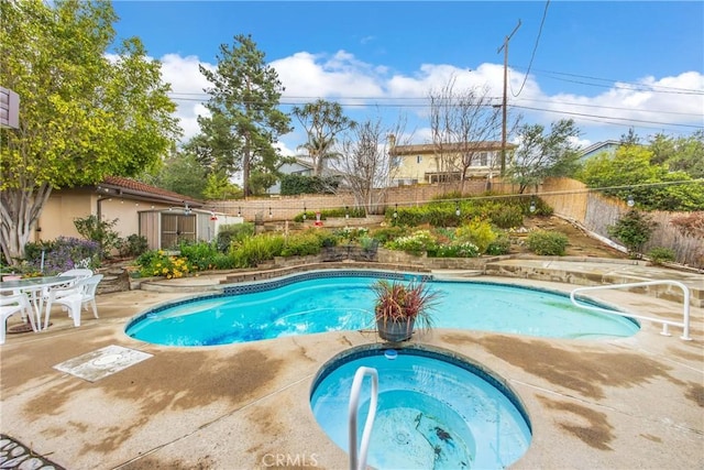 view of pool featuring a fenced in pool, a patio, an in ground hot tub, and a fenced backyard