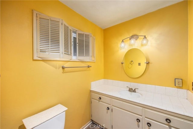 bathroom with toilet and vanity