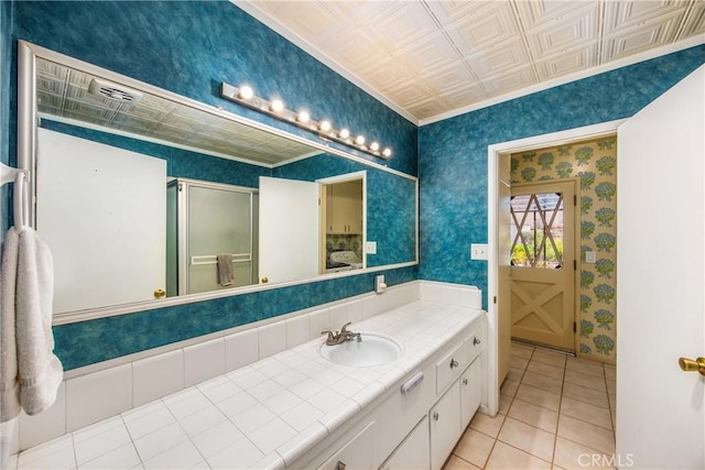 full bathroom with wallpapered walls, vanity, a stall shower, and an ornate ceiling