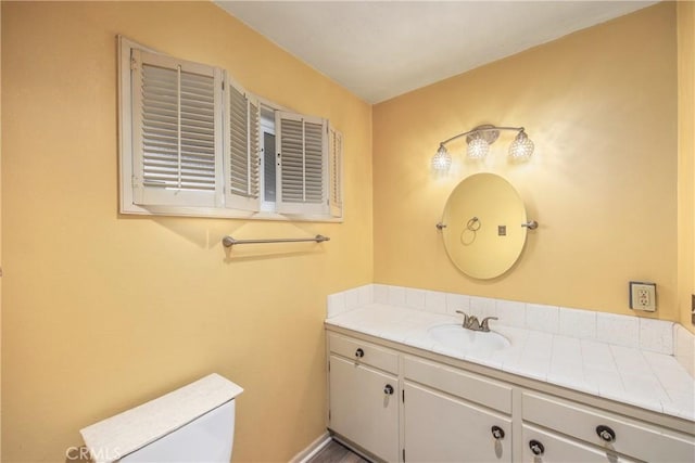 bathroom with toilet and vanity