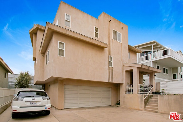 pueblo-style house with a garage