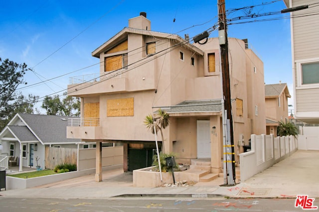 view of front of house featuring a balcony