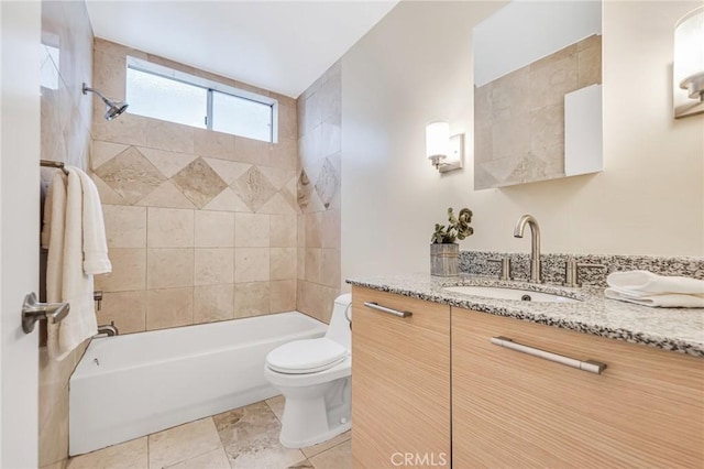 full bathroom featuring tiled shower / bath, vanity, toilet, and tile patterned flooring