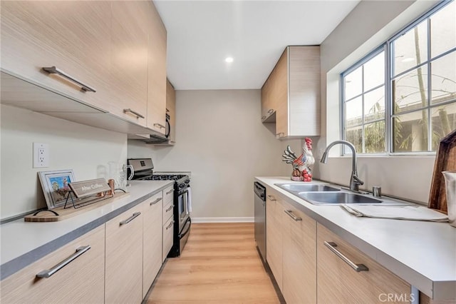 kitchen featuring light hardwood / wood-style floors, stainless steel appliances, light brown cabinetry, and sink