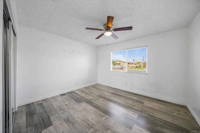 unfurnished room featuring ceiling fan, a textured ceiling, and light hardwood / wood-style flooring