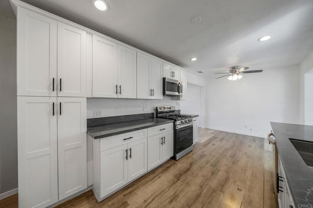 kitchen with sink, light hardwood / wood-style flooring, ceiling fan, white cabinetry, and stainless steel appliances