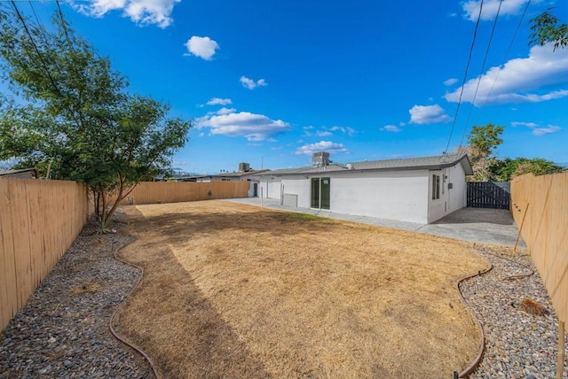 back of house featuring a yard and a patio