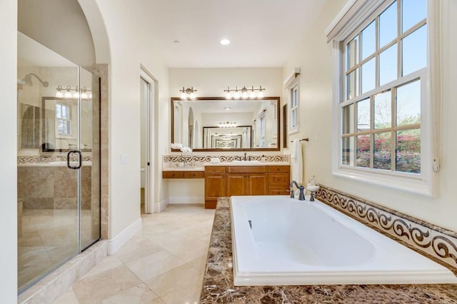 bathroom featuring shower with separate bathtub and vanity