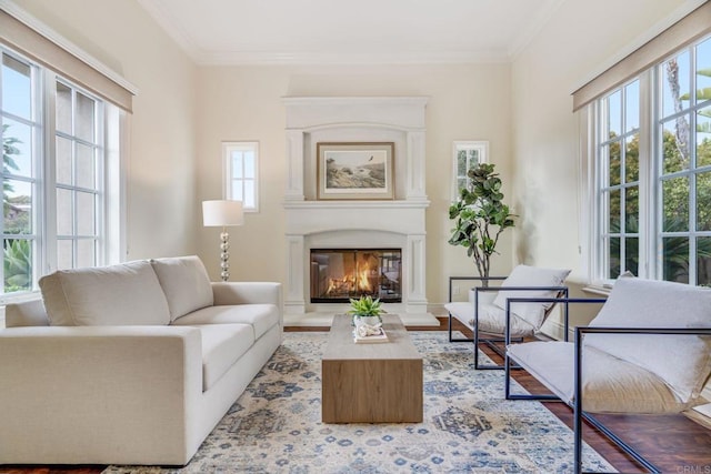 living room featuring hardwood / wood-style flooring, crown molding, and plenty of natural light