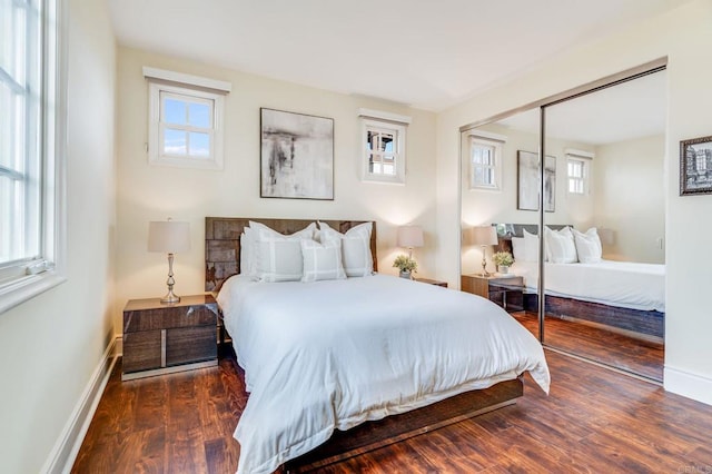 bedroom with a closet and dark hardwood / wood-style floors