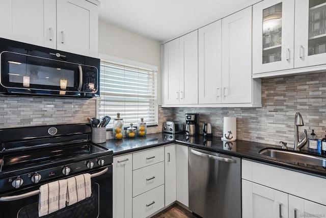 kitchen featuring white cabinetry, sink, decorative backsplash, and black appliances