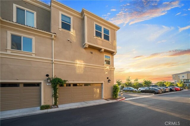 property exterior at dusk with a garage