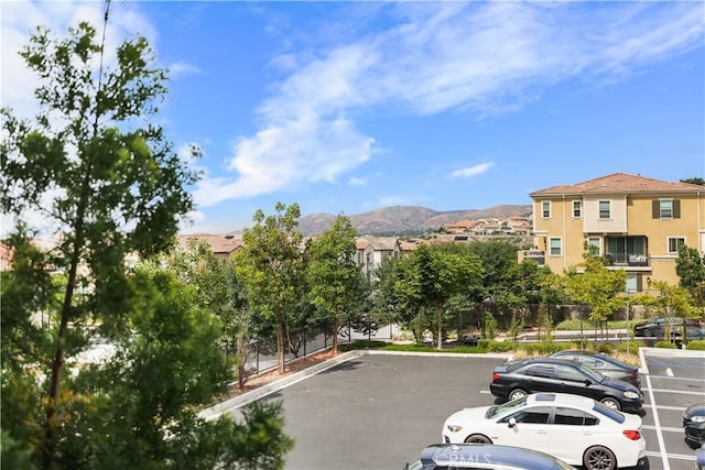 view of car parking with a mountain view