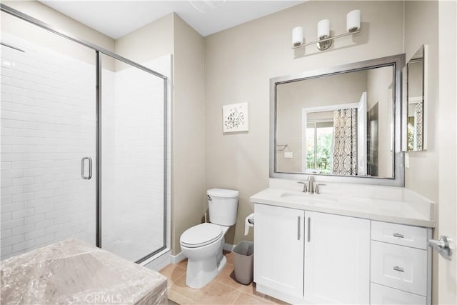 bathroom with a shower with door, vanity, tile patterned flooring, and toilet