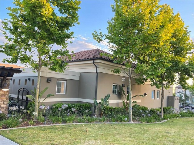 view of property exterior with a lawn