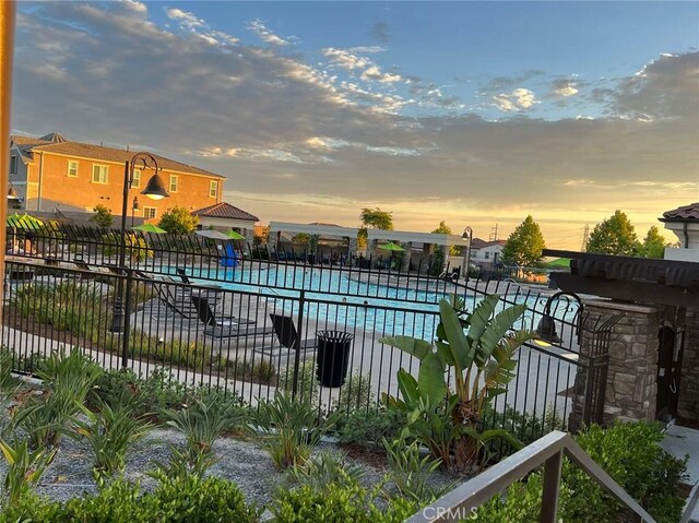 view of pool at dusk