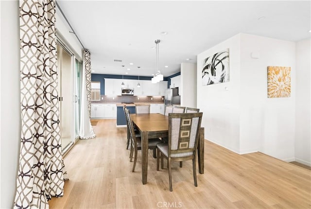 dining area with light hardwood / wood-style flooring