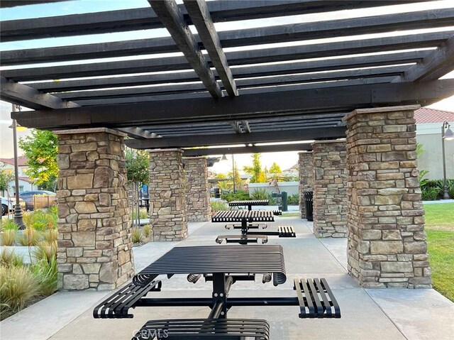 surrounding community with a pergola and a patio area