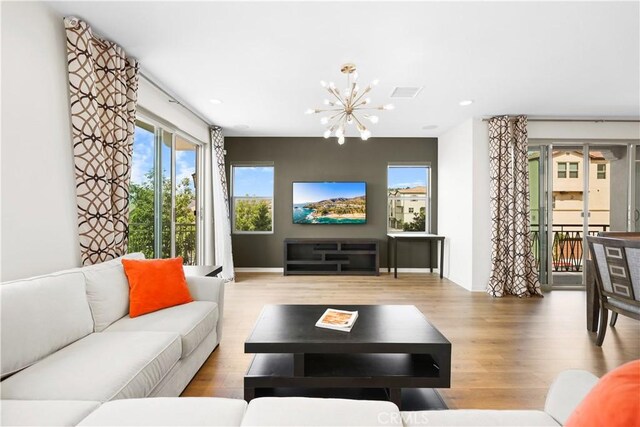 living room featuring a chandelier and hardwood / wood-style floors