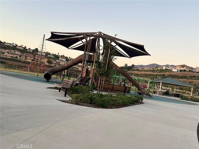 playground at dusk with a gazebo and a mountain view