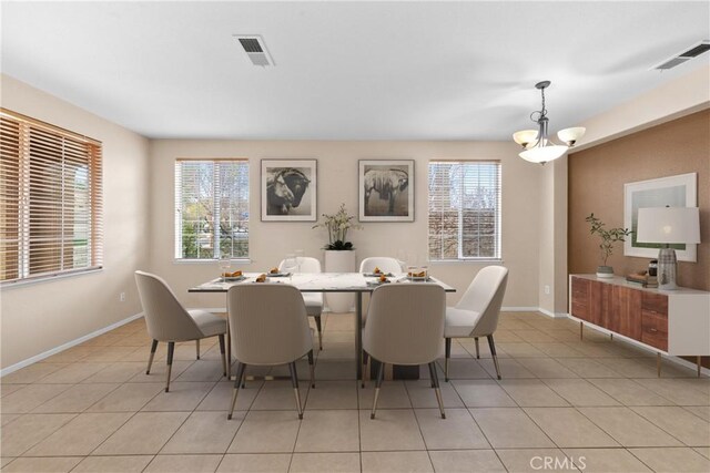 dining room with light tile patterned floors, plenty of natural light, and visible vents