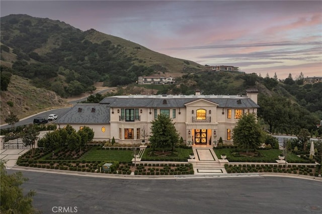 view of front of property with french doors and a mountain view