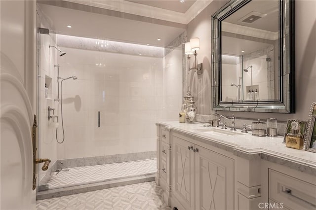 bathroom with crown molding, vanity, and an enclosed shower