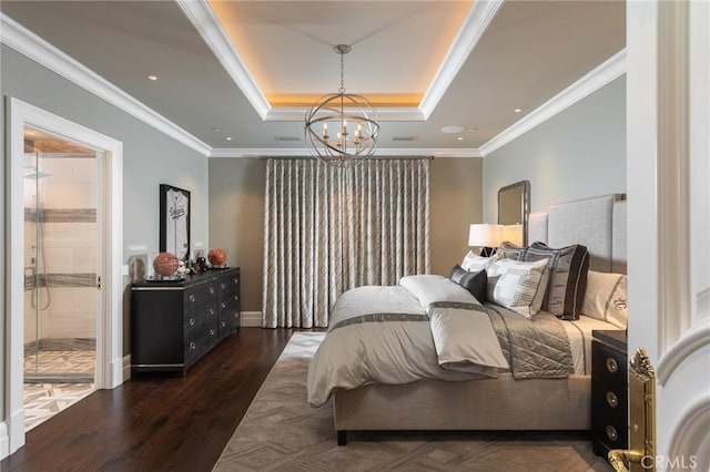 bedroom featuring dark hardwood / wood-style flooring, crown molding, a raised ceiling, and ensuite bathroom