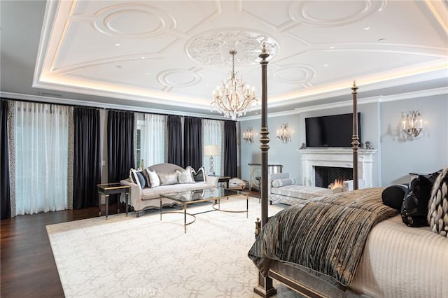 bedroom featuring crown molding, dark hardwood / wood-style floors, a raised ceiling, and an inviting chandelier