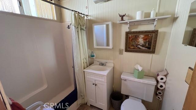 bathroom with vanity, toilet, and walk in shower