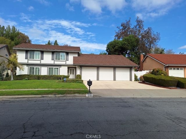 view of front facade with a garage and a front yard