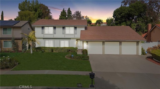 view of front property with a yard and a garage