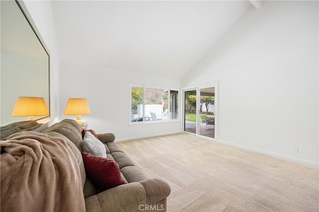 living room with light carpet and high vaulted ceiling