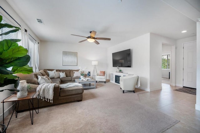 carpeted living room featuring ceiling fan