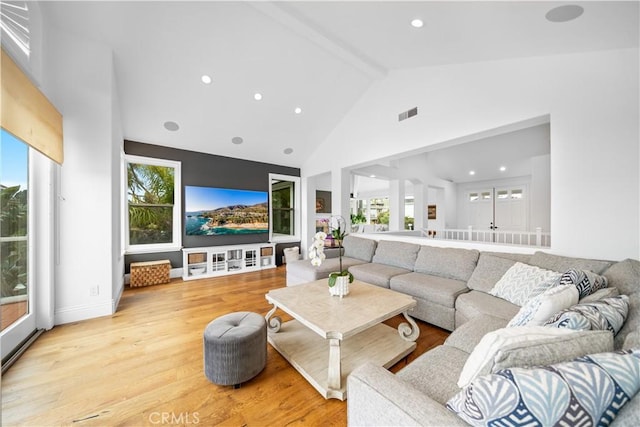 living area featuring high vaulted ceiling, recessed lighting, visible vents, light wood-style floors, and beam ceiling