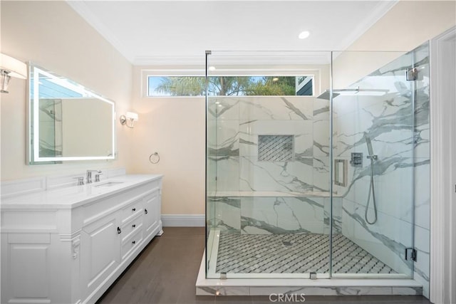 bathroom featuring ornamental molding, a wealth of natural light, vanity, and a marble finish shower