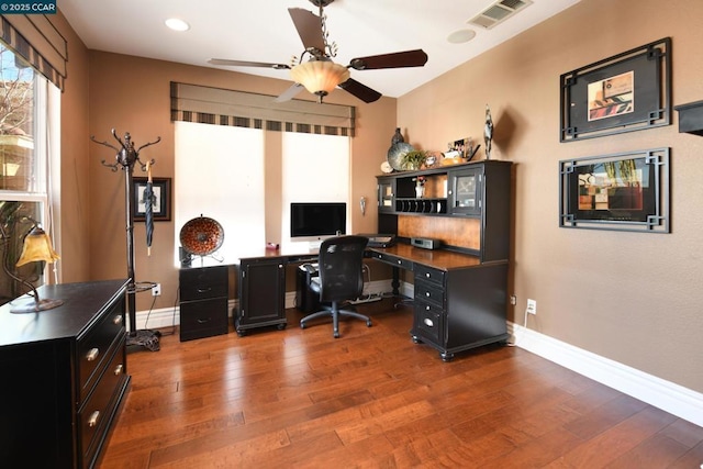 home office with ceiling fan and dark hardwood / wood-style flooring