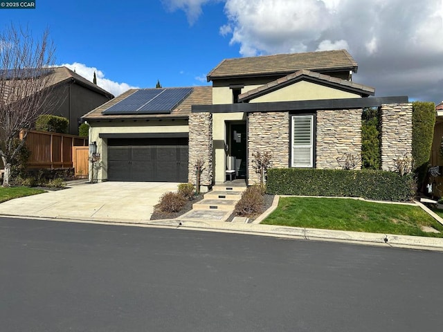 view of front of house with a garage and solar panels